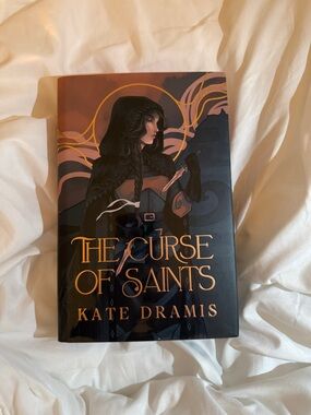 The Curse of Saints by Kate Dramis — Dark Navy & Gold Hardcover Fairyloot
